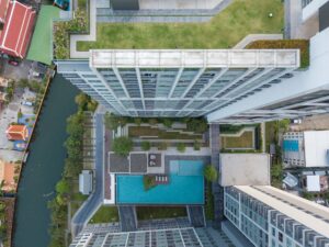 top view of a condominium with swimming pool and garden