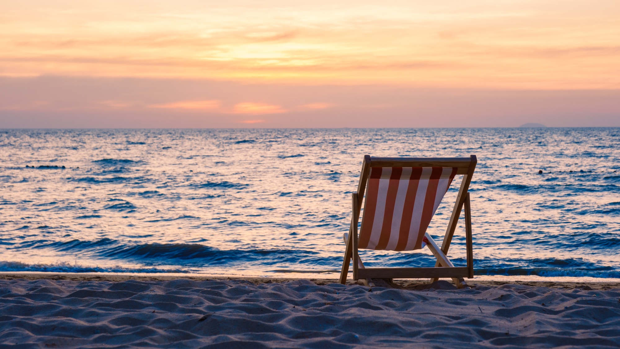 beach chair on the beach with palm trees during sunset at Na Jomtien Beach Pattaya Thailand