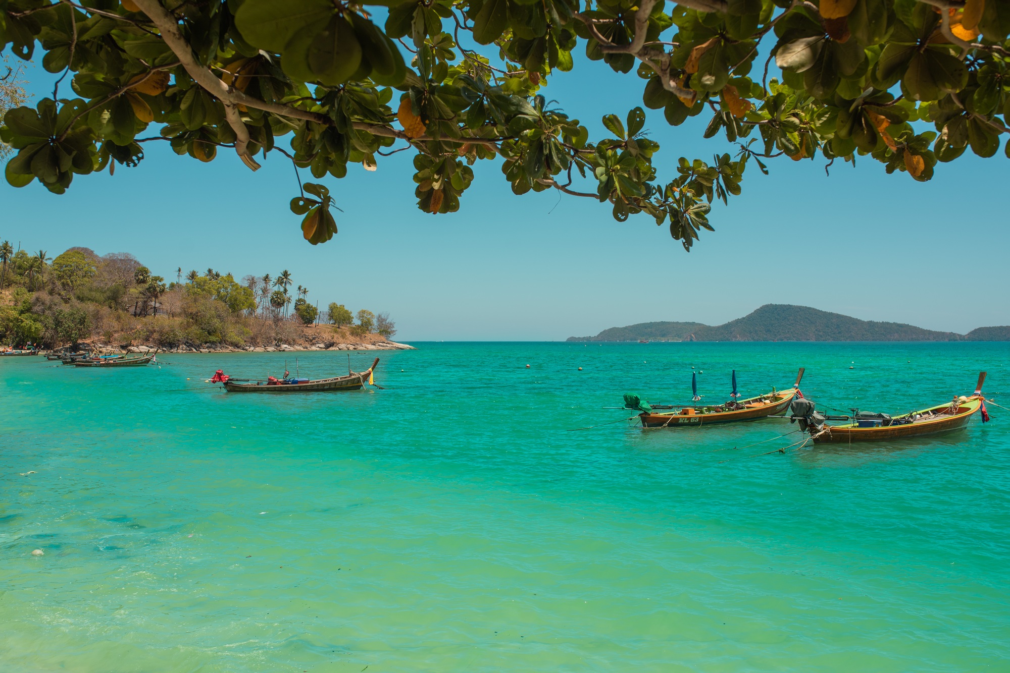 Fishing boats on the coast of the sea in Thailand on the island of Phuket