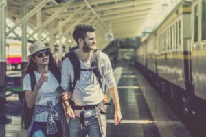 Multiethnic Travellers are walking and finding the train at the train station,