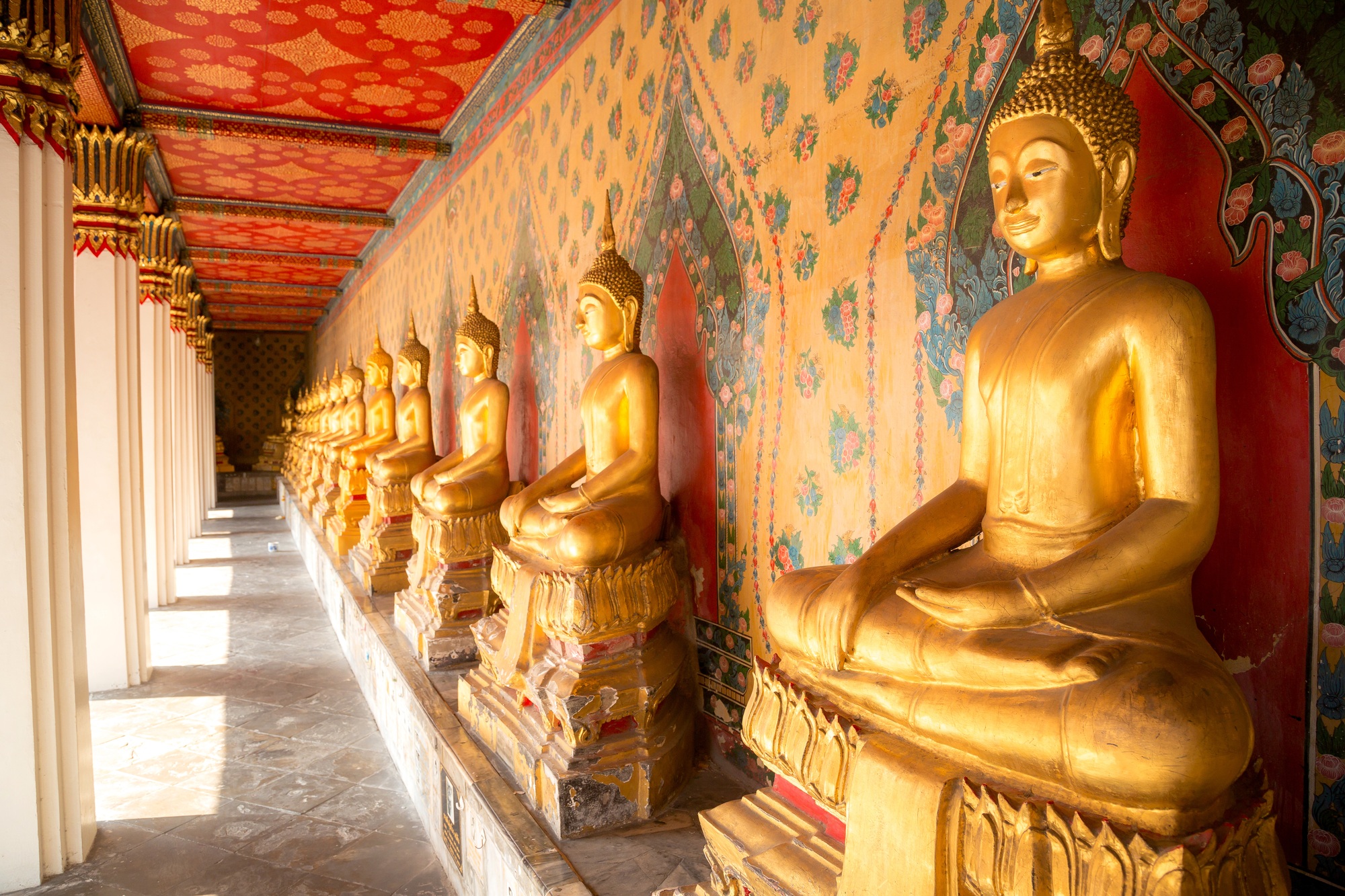 Row of golden buddha statue at Wat Arun, Bangkok Thailand.