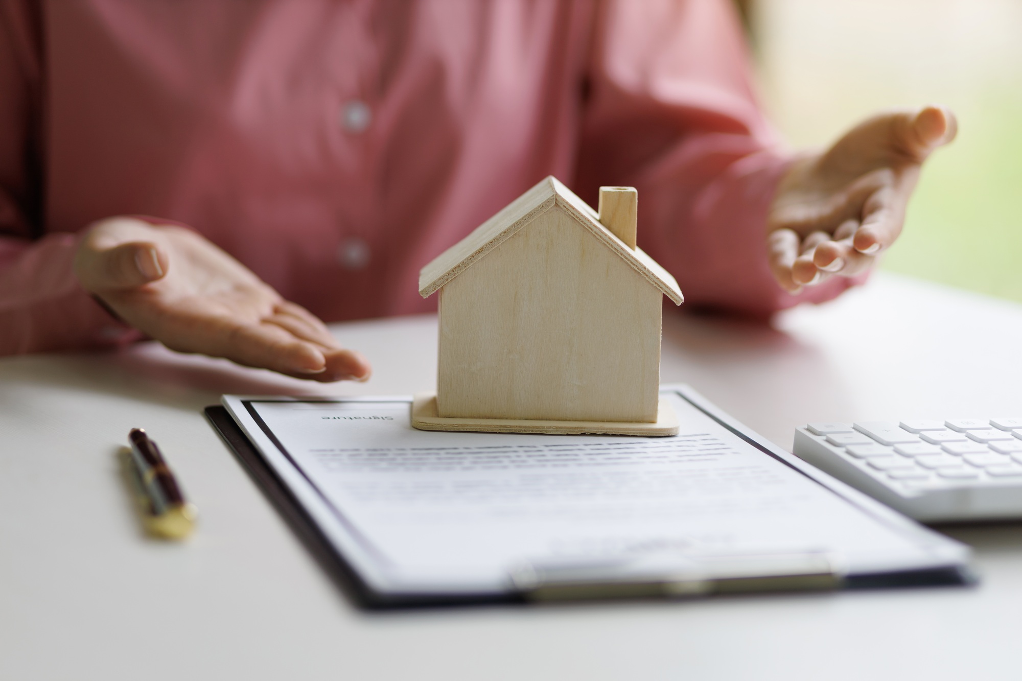 The real estate agent is explaining the terms in the contract agreement document.