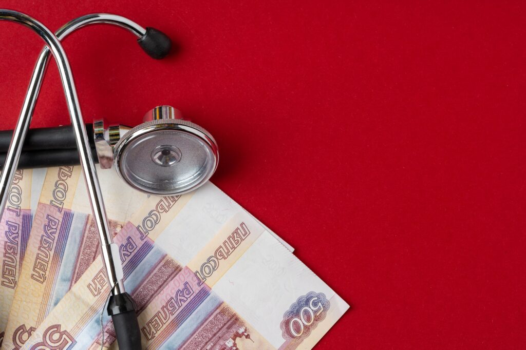 Pile of Russian Rubles with medical stethoscope. Medical expenses concept